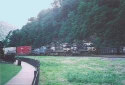 Three trains passing on triple-track mainline of Norfolk Southern Railway at Horseshoe Curve in Logan Township